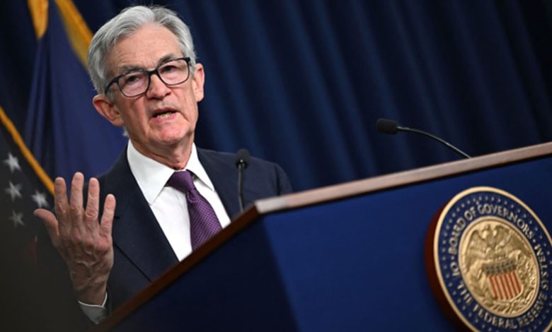 Fed holds rates steady, takes less confident view on inflation