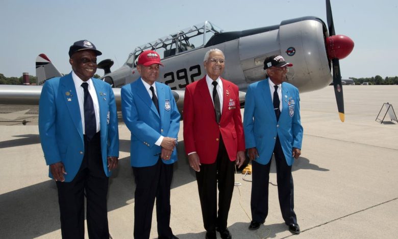 From left to right, Tuskegee Airmen pilots Lt. Colonel Washington Ross, Lt. Col. Harry Stewart, Colonel Charles McGee and Lt. Col. Alexander Jefferson stand next to a Tuskegee Army Airfield AY-6 Texan fighter plane during a ceremony to honor the airmen at Selfridge National Airbase in Harrison Township, Michigan, on June 19, 2012.