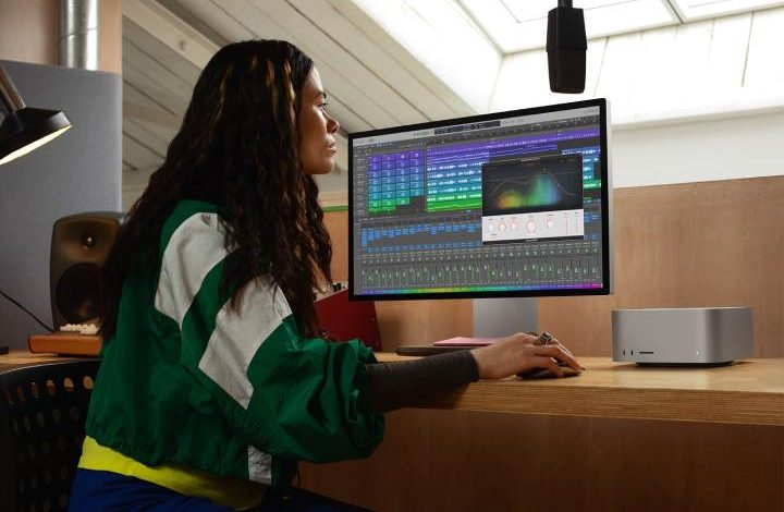 A person using a Mac Studio with an Apple Studio Display.