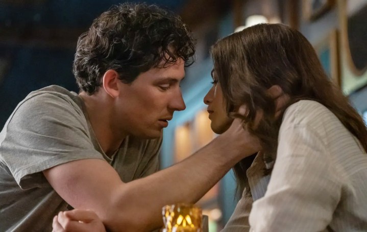 Josh O'Connor leans in to kiss Zendaya in a still from the movie Challengers.