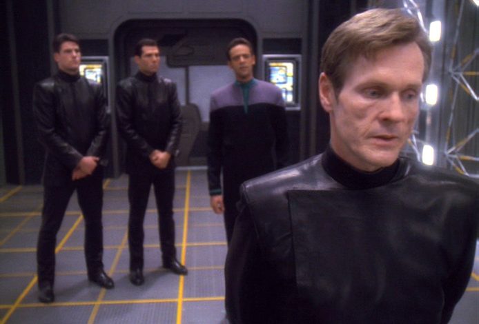 William Sadler as Sloan (right), Deputy Director of Section 31, stands on a holodeck with Julian Bashir and two S31 agents.