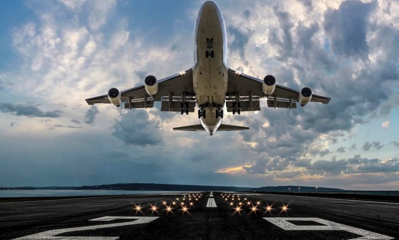 Passenger airplane taking off at sunset.