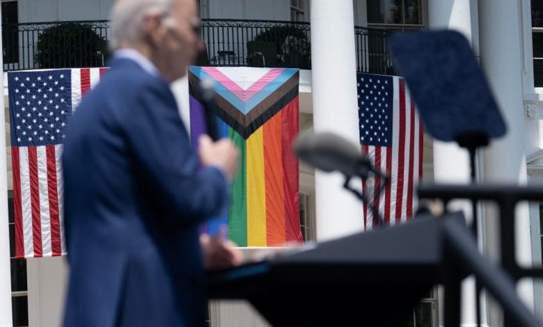 Biden with US, pride flags on White House in background