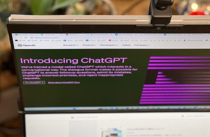 OpenAI's ChatGPT blog post is open on a computer monitor, taken from a high angle.