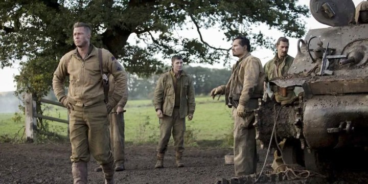 Men stand around a tank in Fury.