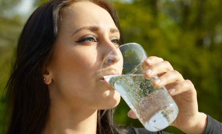 Woman with glass of sparkling water