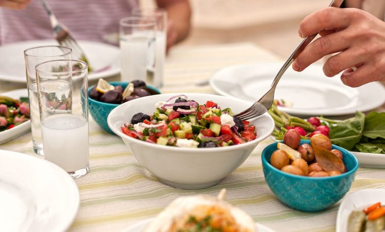 Eating Lunch with Fresh Salad and mediterranean Appetizers