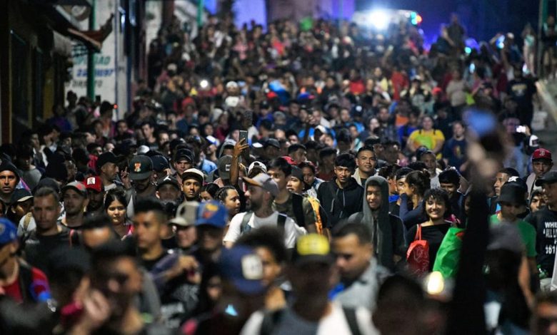 Migrants from a caravan in Tapachula, Chiapas state, Mexico, march while heading to the US border