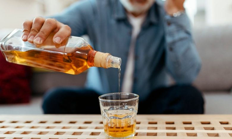 Older man pouring whiskey