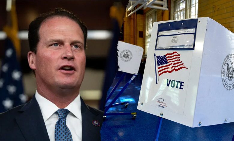 Rep. August Pfluger of Texas next to a voting booth