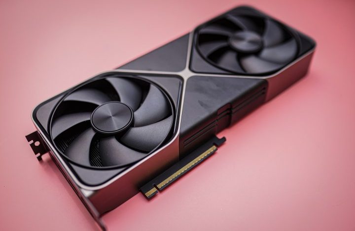 The RTX 5080 sitting on a pink background.