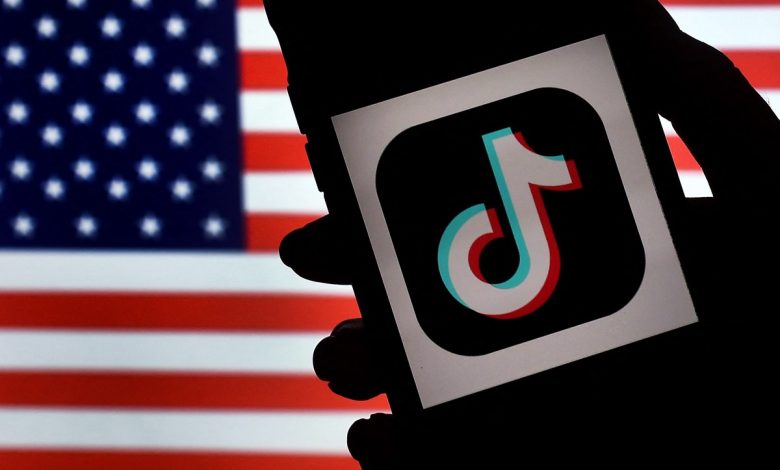 In this photo illustration, the social media application logo, TikTok is displayed on the screen of an iPhone on an American flag background on August 3, 2020 in Arlington, Virginia. - The US Senate voted on August 6, 2020, to bar TikTok from being downloaded onto US government employees' telephones, intensifying US scrutiny of the popular Chinese-owned video app. The bill passed by the Republican controlled Senate now goes to the House of Representatives, led by Democrats. (Photo by Olivier DOULIERY / AFP) (Photo by OLIVIER DOULIERY/AFP via Getty Images)