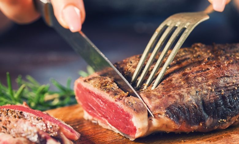 Woman cutting steak