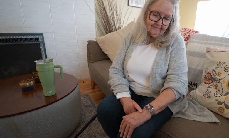 An old woman tracking her health on a smartwatch.