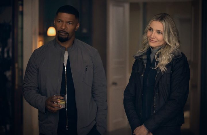 Jamie Foxx and Cameron Diaz stand next to each other and stare in Back in Action.