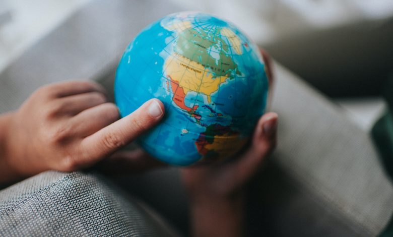 Child pointing to a globe