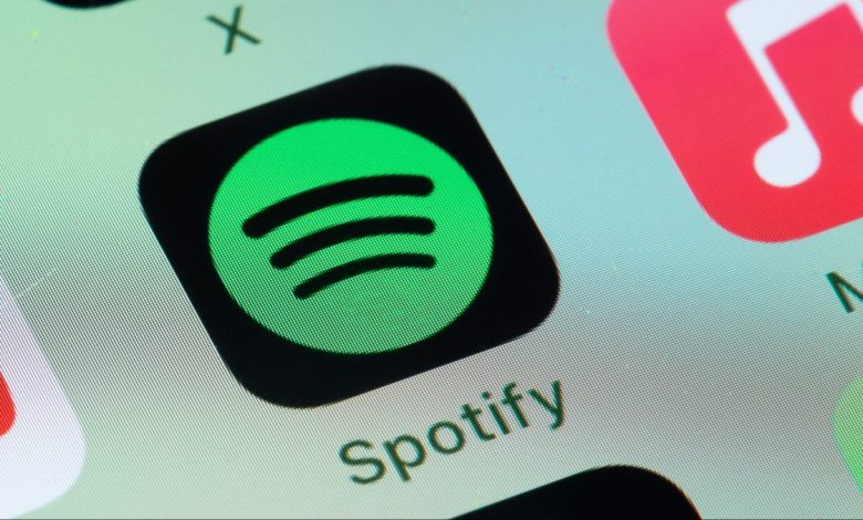 Spotify, Apple Music on smart phone screen.