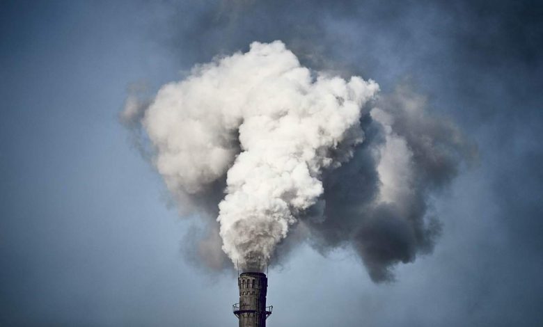 Thick smoke is billowing out of the chimney of a Chinese factory.