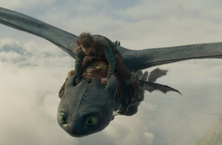 A boy rides a dragon in the skies.