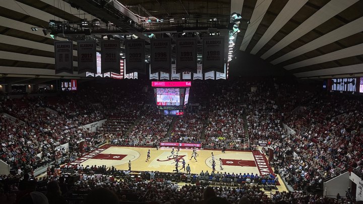 Fans watch the basketball game inside Coleman Coliseum.