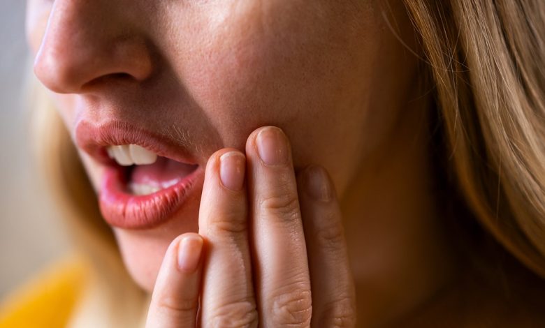 Woman having mouth pain or toothache