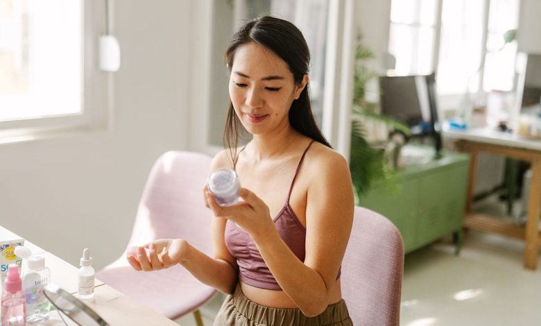 woman reading the ingredients on a skincare product