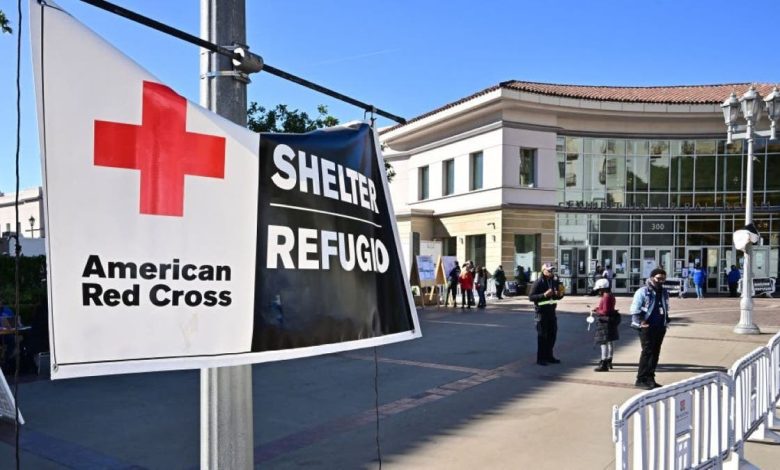 People are seen outside a wildfire shelter at the Pasadena Convention Center on January 21, 2025, where FEMA disaster assistance is available. FEMA has received more than 91,000 applications for assistance from both Los Angeles City and County, and has delivered more than $32 million to wildfire survivors so far. The deadline to register for FEMA and SBA asisstance is March 10, 2025. (Photo by Frederic J. BROWN / AFP) (Photo by FREDERIC J. BROWN/AFP via Getty Images)