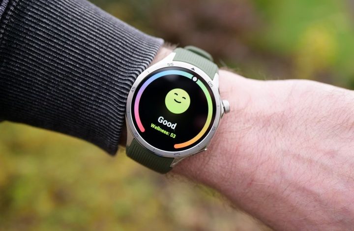 A person wearing the OnePlus Watch 3, showing the Wellness screen.