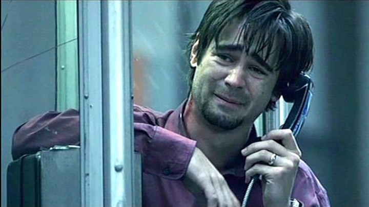 Colin Farrell holding a pay phone and crying in a scene from Phone Booth.