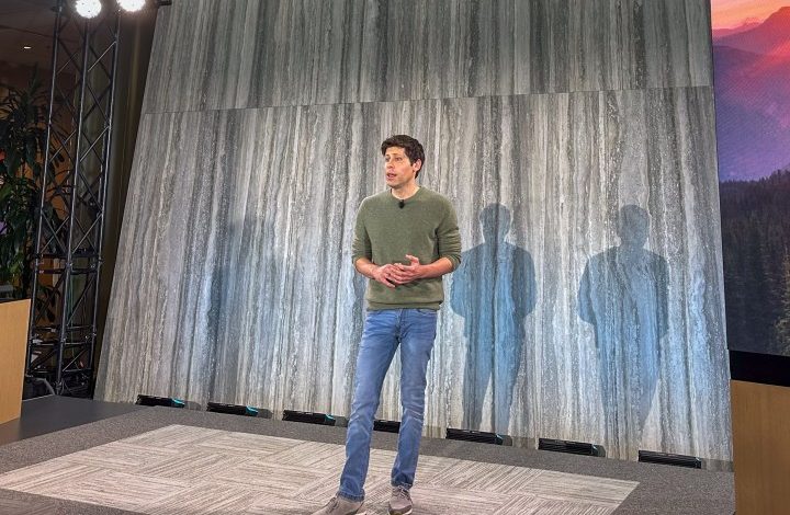 OpenAI CEO Sam Altman standing on stage at a product event.