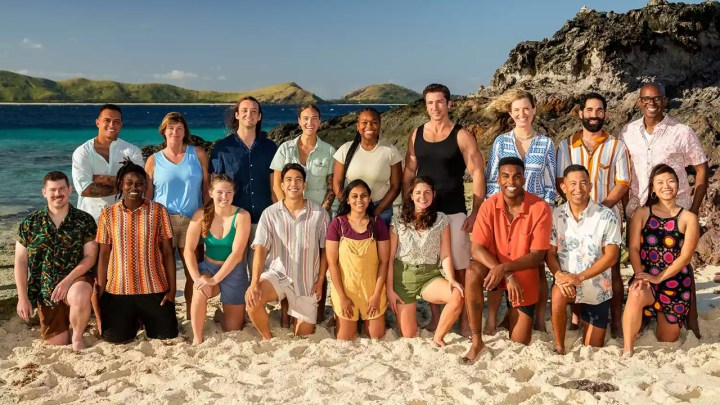 The cast of Survivor 48 posing on the beach