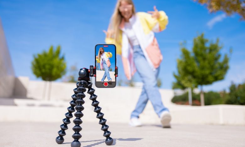 Teenage girl filming video of herself on mobile phone