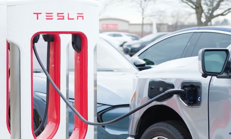 A car charges at a Tesla Supercharger