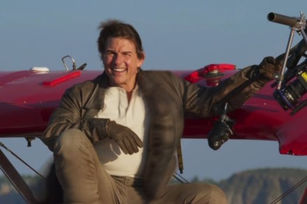 Tom Cruise hangs upside down from a biplane in Mission: Impossible 8 stunt