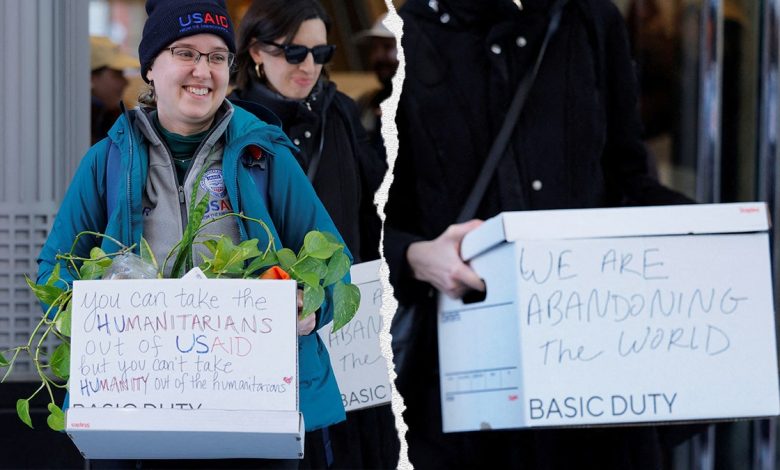 Recently fired USAID workers with messages on boxes