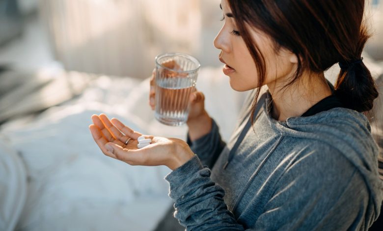 Woman holding pills