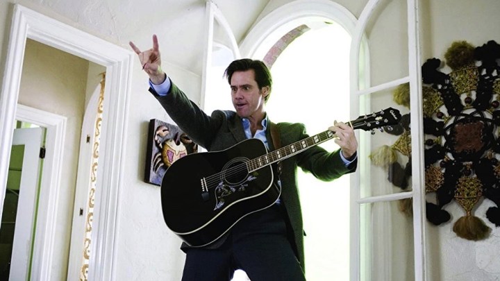 Jim Carrey puts up his fingers with a guitar in Yes Man.