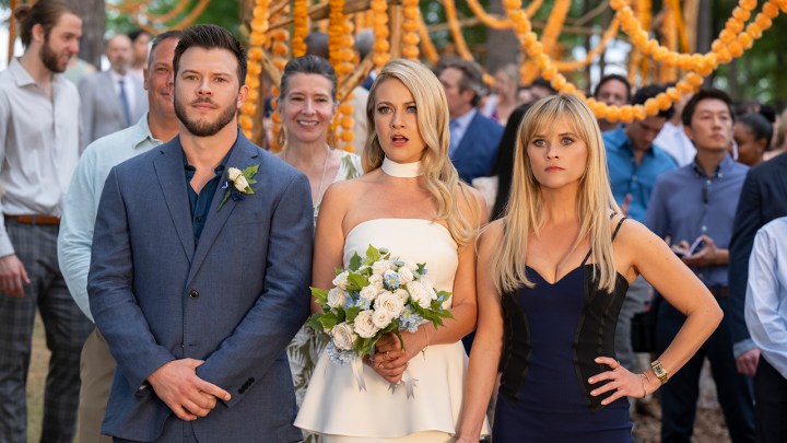 Two people stand with a bride looking angry in You're Cordially Invited.