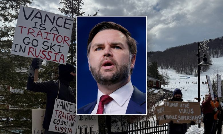 JD Vance is pictured in front of protesters