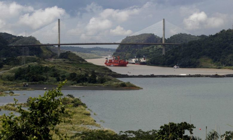 A cargo boat navigates on the Panama Canal next to the expansion project of the Panama Canal on the pacific side in Panama City