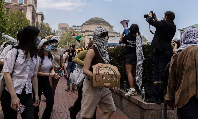 Student protesters march around their encampment on the Columbia University campus