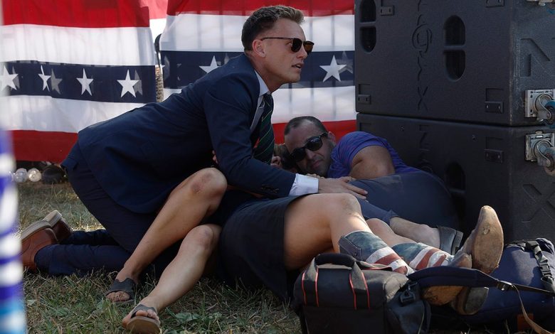 A Secret Service member and members of the crowd are seen at republican presidential candidate former President Donald Trump's rally