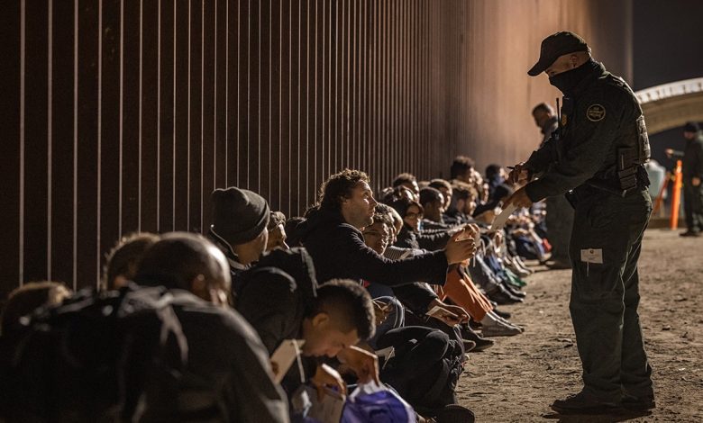 A CBP agent and migrants
