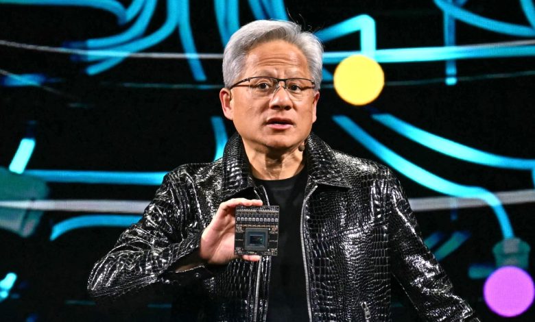 Jensen Huang holds up chip at CES 2025