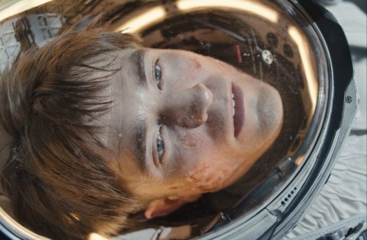 Robert Pattinson as an astronaut stares with a blank expression on his face in "Mickey 17."