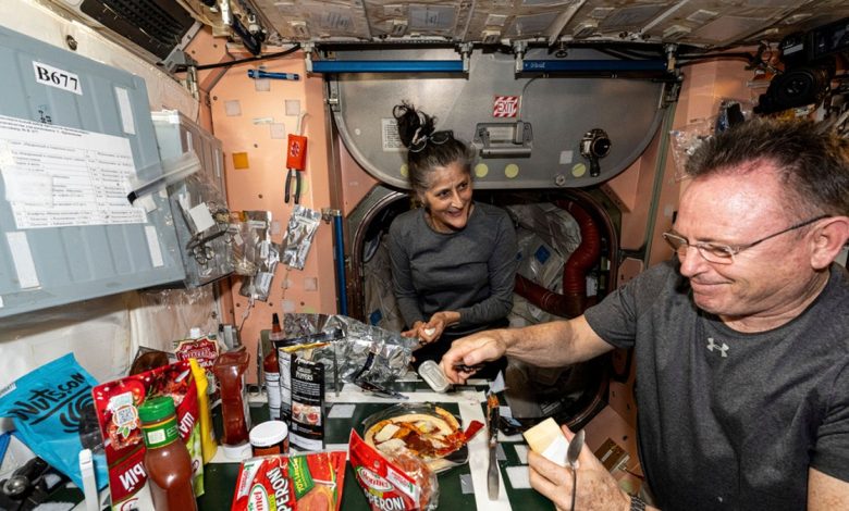 Wimore and Williams eating at the ISS