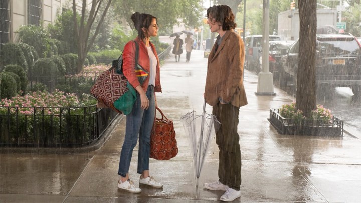 A woman and man stop to talk to one another on the street in the rain in A Rainy Day in New York.