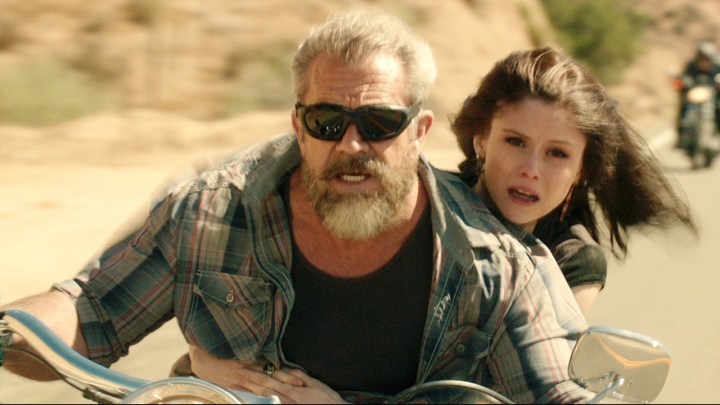 A man riding a motorcycle with sunglasses on, a young woman behind him in Blood Father.