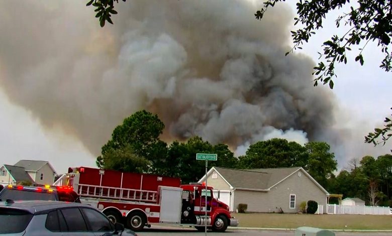 Crews work to contain a fire in the Carolina Forest area west of the coastal resort city of Myrtle Beach, S.C., Sunday, March 2, 2025, where residents were ordered to evacuate several neighborhoods.