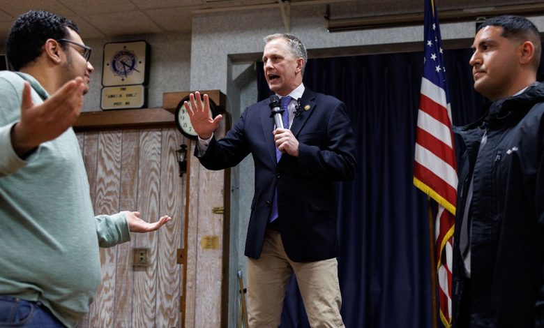 A pro-Israel supporter, left, confronts Rep. Sean Casten while disrupting a town hall at American Legion Post 80 on March 19, 2025, in Downers Grove, Illinois. After this protester and several pro-Palestinian protesters interrupted Casten, the town hall was shut down by the Downers Grove police.